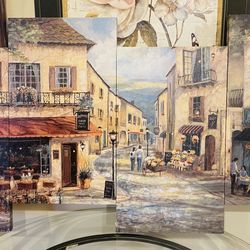 Charming 4-panel canvas wall art. This piece has a beautiful European street scene with cafes, shops, and people. Nice set for living room or dining a