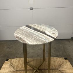 Round marble or agate stone top paired with a sleek, cross-base metal frame in a gold