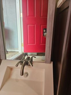 Bathroom sink with faucet and mirror