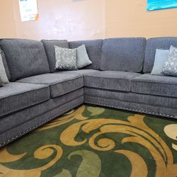 Charcoal gray sectional with nailhead trim