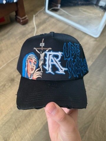 Rude Awakenings Hat Crucifixion