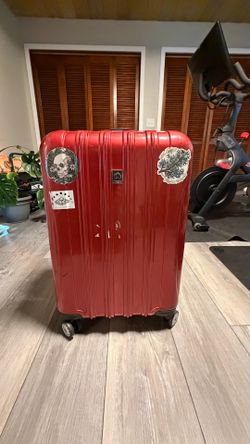 Large red used suitcase