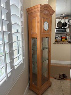Broyhill illuminated cabinet with clock