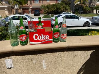 Old soda bottles with a six pack holder