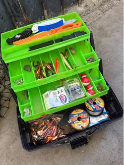 Tackle box with assorted hooks and lures and fishing net