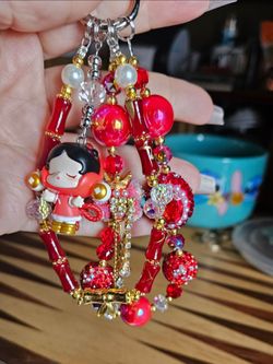 handmade beaded keychain or phone charm featuring a Skullpanda figure.