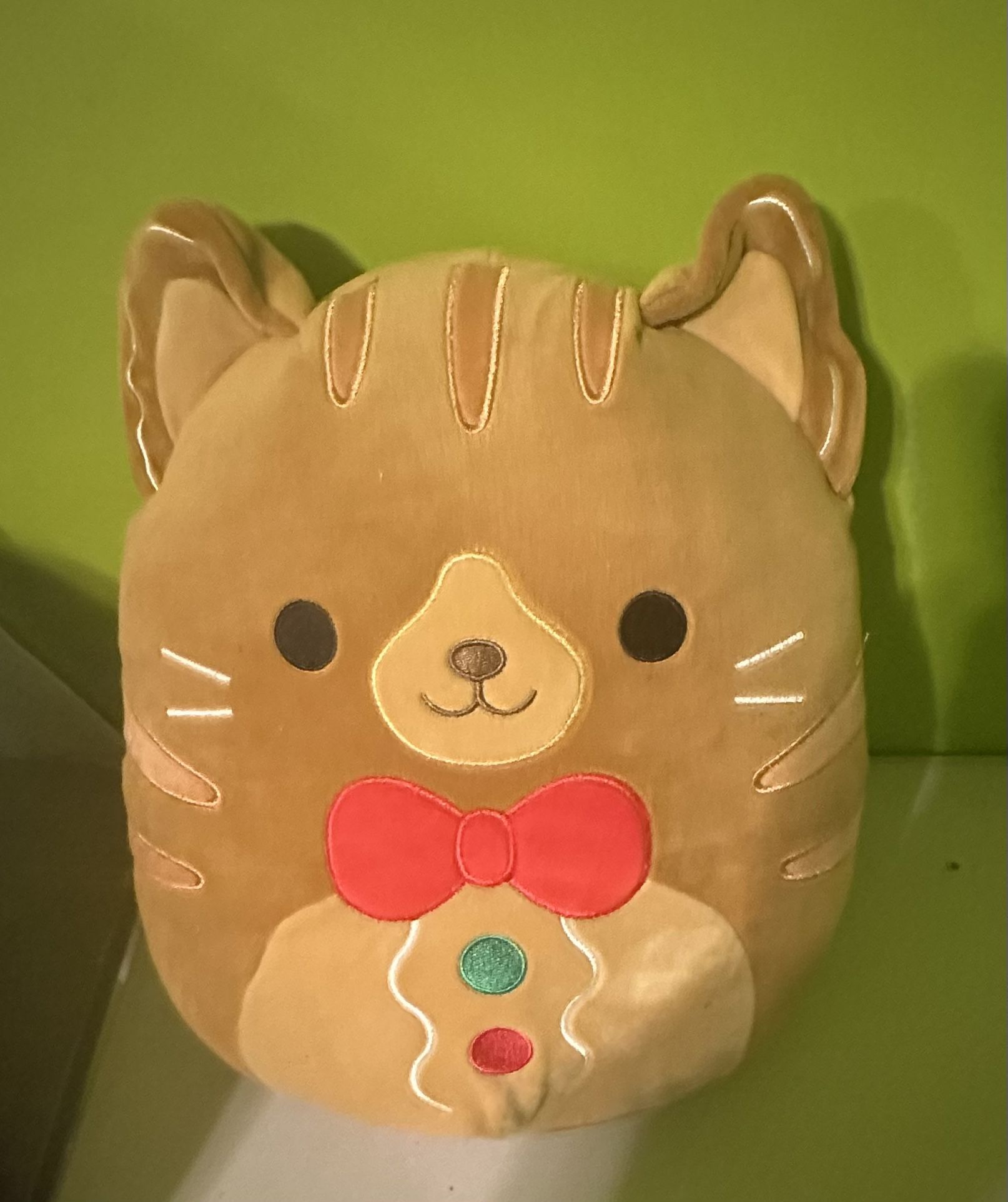 Squishmallows Jones the Gingerbread Cat plush with a Christmas bowtie Stuffed Animal