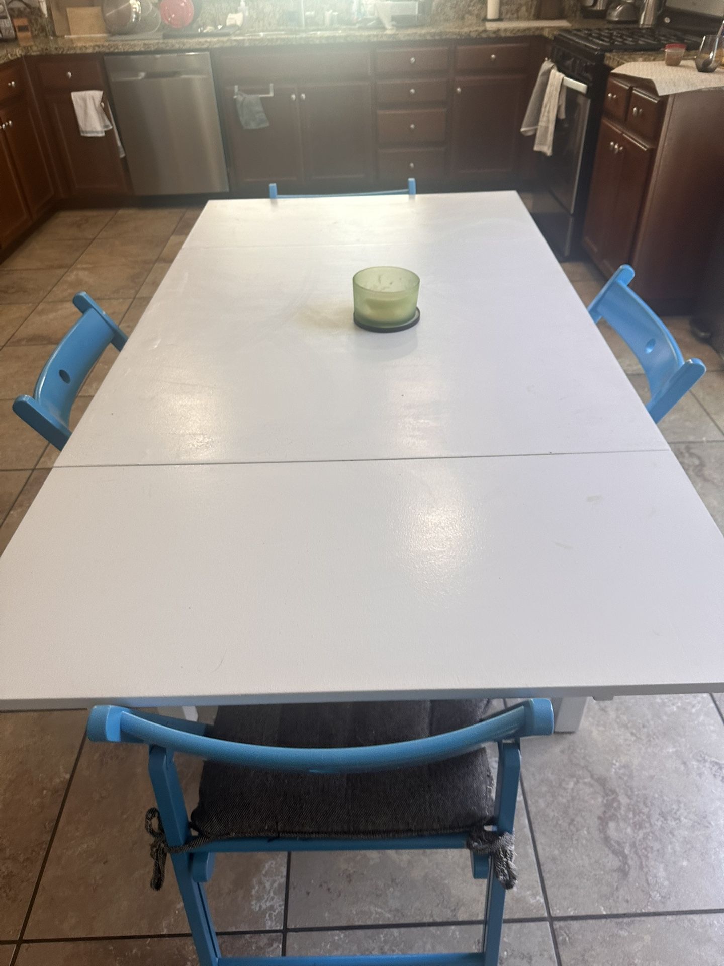 White Dining Table with 4 Blue Chairs