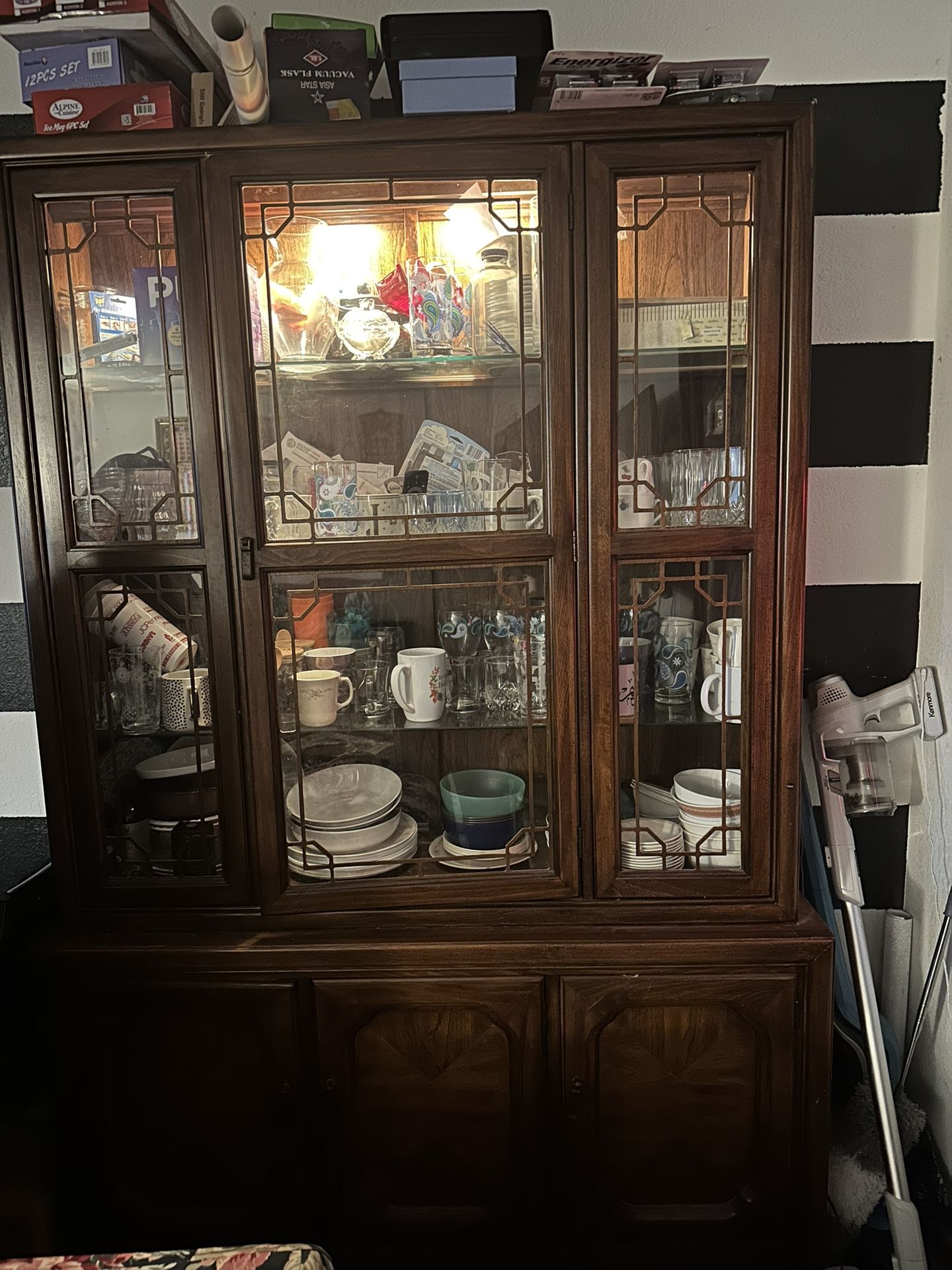 vintage wooden china cabinet / hutch with glass doors and display lights.