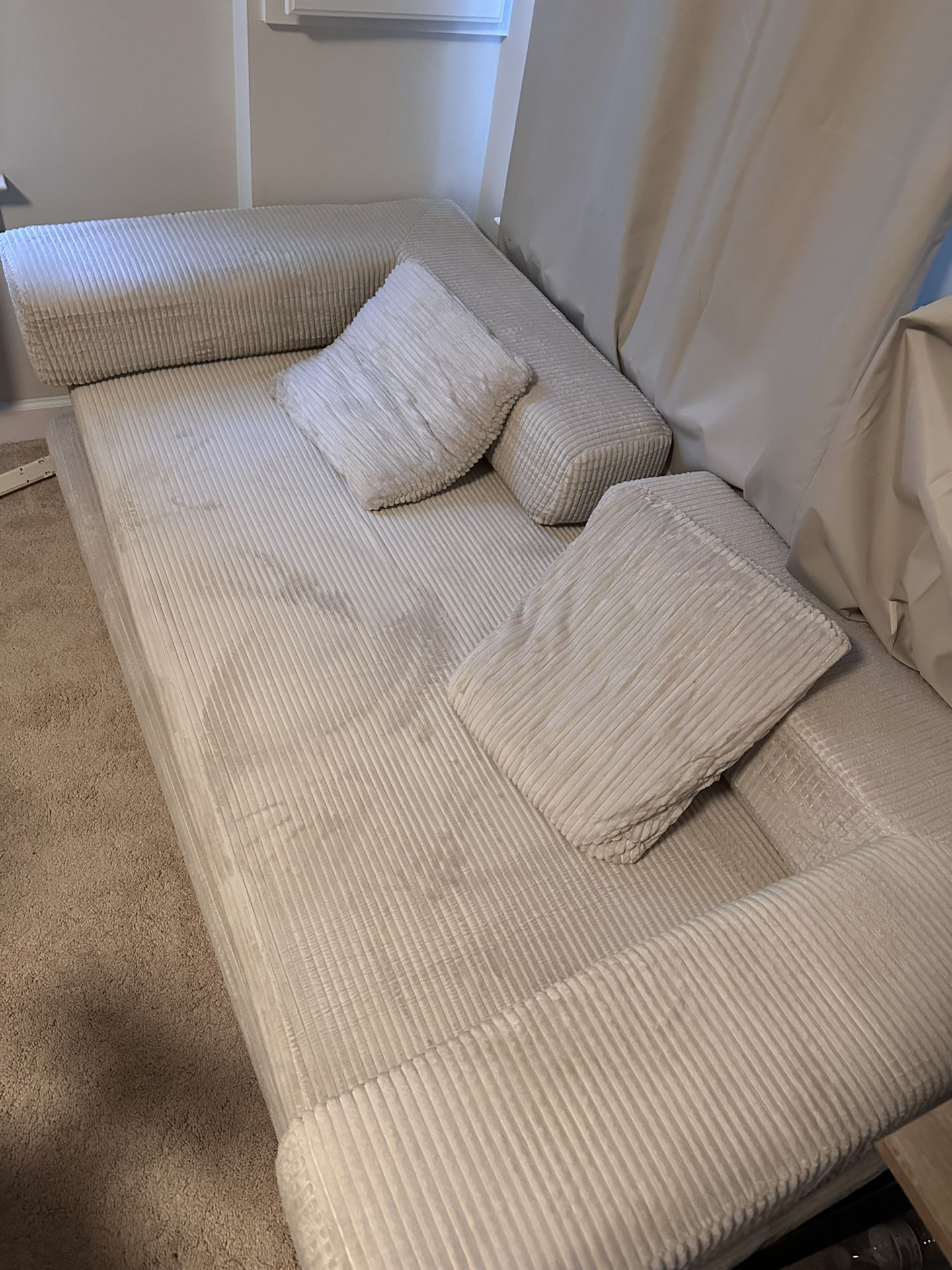 A NEW assemblable off-white sofa