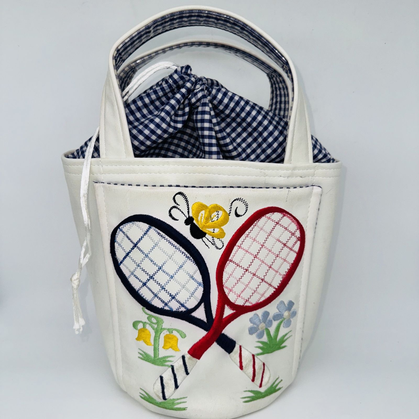 Handmade VNTG Tennis Rackets Top Handle Tote Bag White Vinyl Emroidered Handbag This is from the 1970s. It is faux leather. A.k.a. vinyl the bag is r