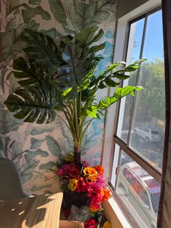 6 foot tall, fake palm tree with little flowers on bottom