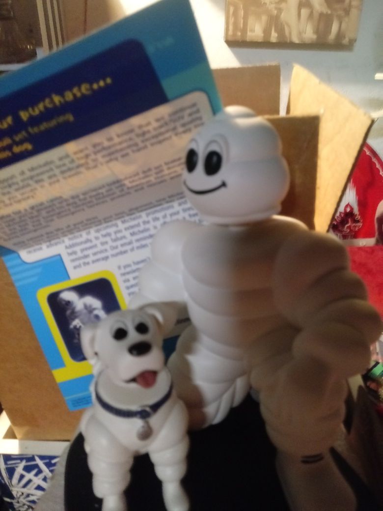 Porcelain bobblehead Michelin Man in dog