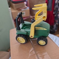 John Deere toy tractor with a front-mounted hay fork loader