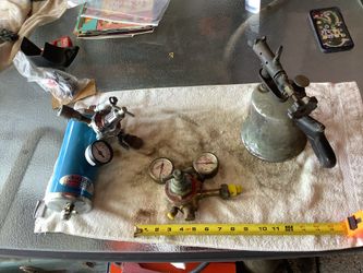 SHARPE 18C-500 Air Regulator Assembly (left) and two vintage industrial-style pressure regulators and an acetylene torch, often used for automotive pa