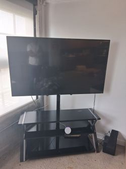 70 inch Television w/ 3 glass shelves stand.
