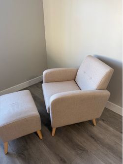 Tan linen upholstered lounge chair and ottoman