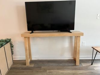 Wooden TV stand or hallway table.