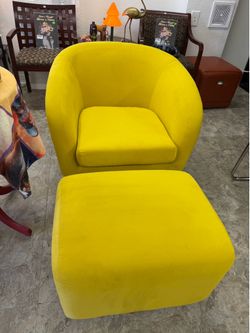 Swivel tub chair features curved arms and a matching ottoman.