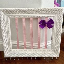 Adorable Girls Hair Bow And Jewelry Accessory Holder   Has hooks on the bottom for necklaces or jewelry or hair ties.  Hangs on the wall.  In good con