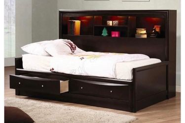 daybed with bookcase attached along and storage drawers under it