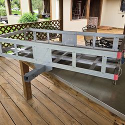 Vehicle hitch mounted carry basket