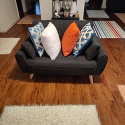 A CUTE BLUE SOFA CAN HOLD UP A 300 _ 50_ POUND PERSON