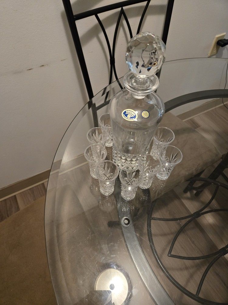 Crystal gorgeous decanter with 8 glasses; NOTE: If it's posted; it's available.