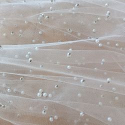 Bride accessories veil

Pearl Wedding Veil White Color hip Length made of tulle with pearl beads. Made with metal comb
Measurements
Width of comb 3.5 