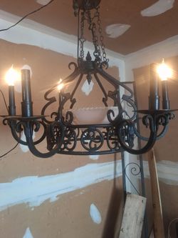 1900s wrought iron chandelier w rare pink crystal insert  it jst needs 3 more bulbs this is a really nice gothic vintage piece