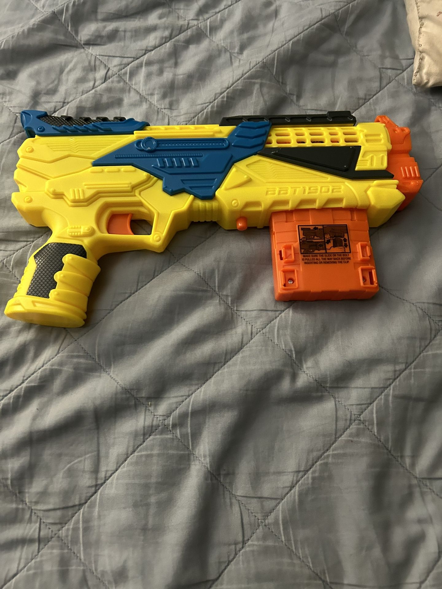 yellow, blue, black and orange nerf gun
