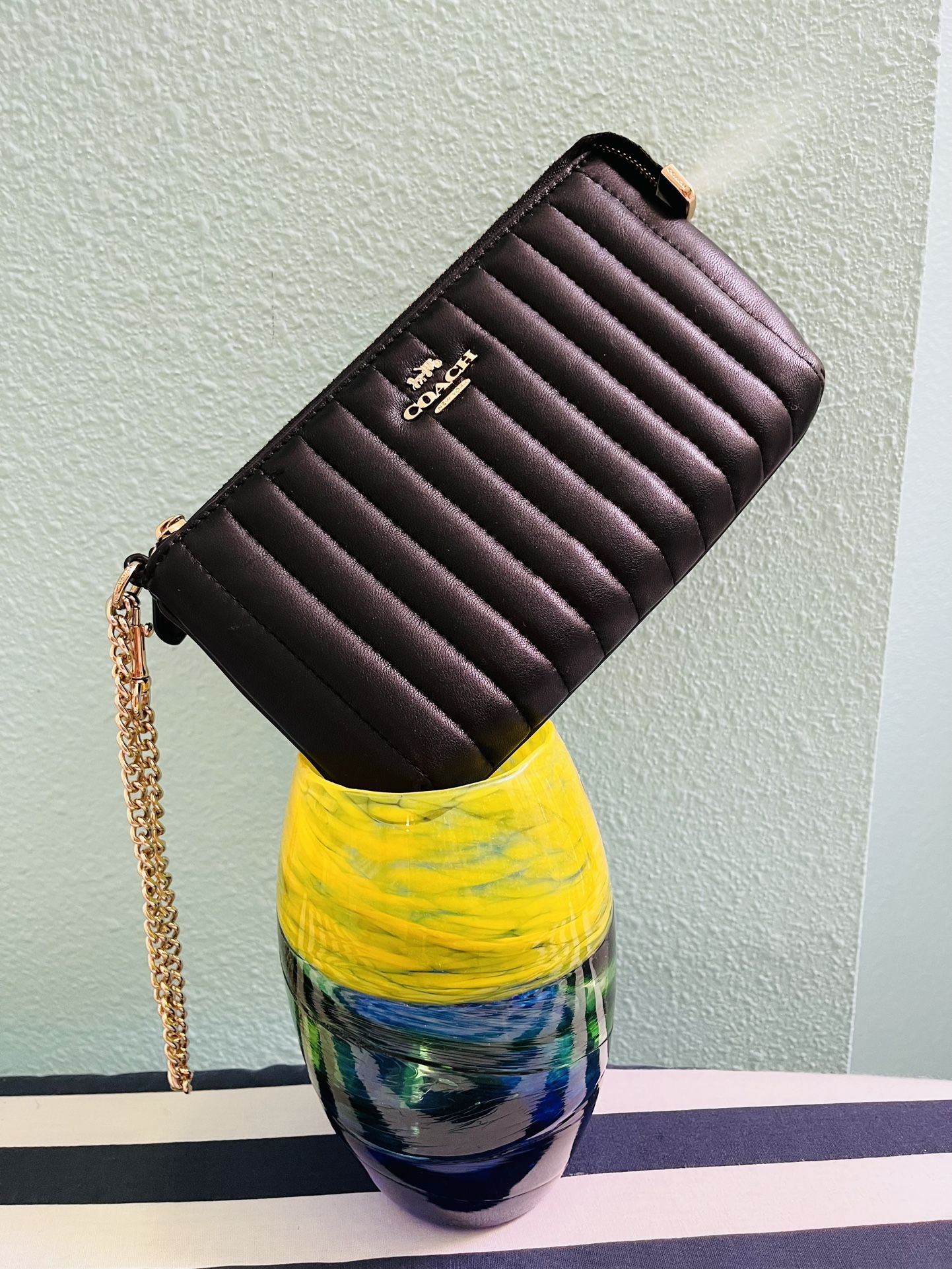 Coach wristlet with linear quilting