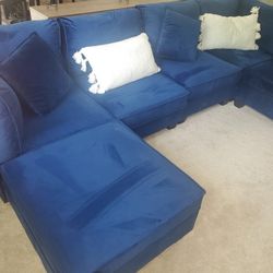 Blue Sectional With Removable Ottomans.