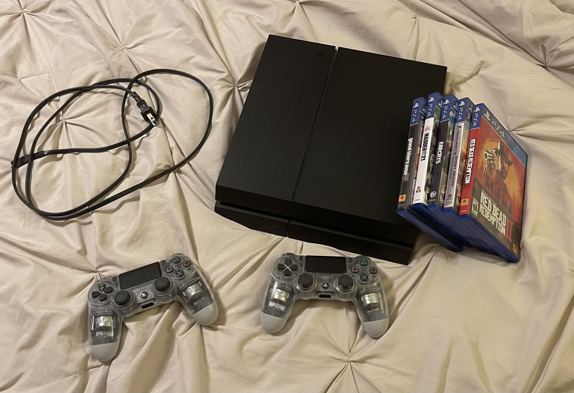 PS4 Console, 2 Controllers and 5 Games.