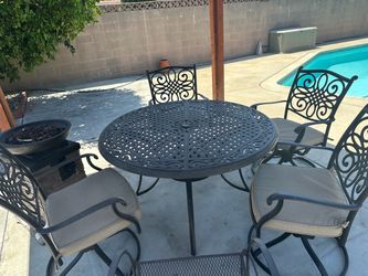 Patio table, chairs, fireplace and gas cylinder