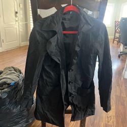 Black trench coat with button-up front and pockets