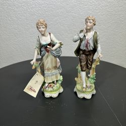 Capodimonte vintage figurines of a girl and a boy