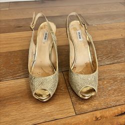 Gold glitter open-toe heels with ankle strap.