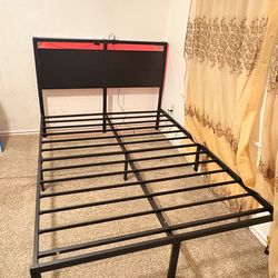 Metal L.E.D light bed frame with electric port.