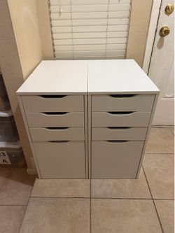 2 White 4-Drawer Cabinets  White storage cabinets with 4 drawers (large bottom drawer). Good condition. Great for office, crafts, or organization.