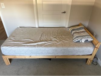 2 wooden frame beds with bed