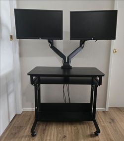 Desktop and two HP screens with articulated arm.