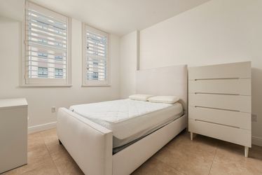 Bed frame, tall dresser, smaller dresser/nightstand, and mattress.