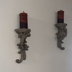 Pair ornate wall sconces with candles