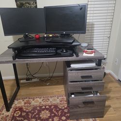 Desk with three drawers and sit stand.