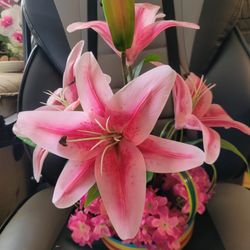 Vintage artificial pink lillies in a striped bowl