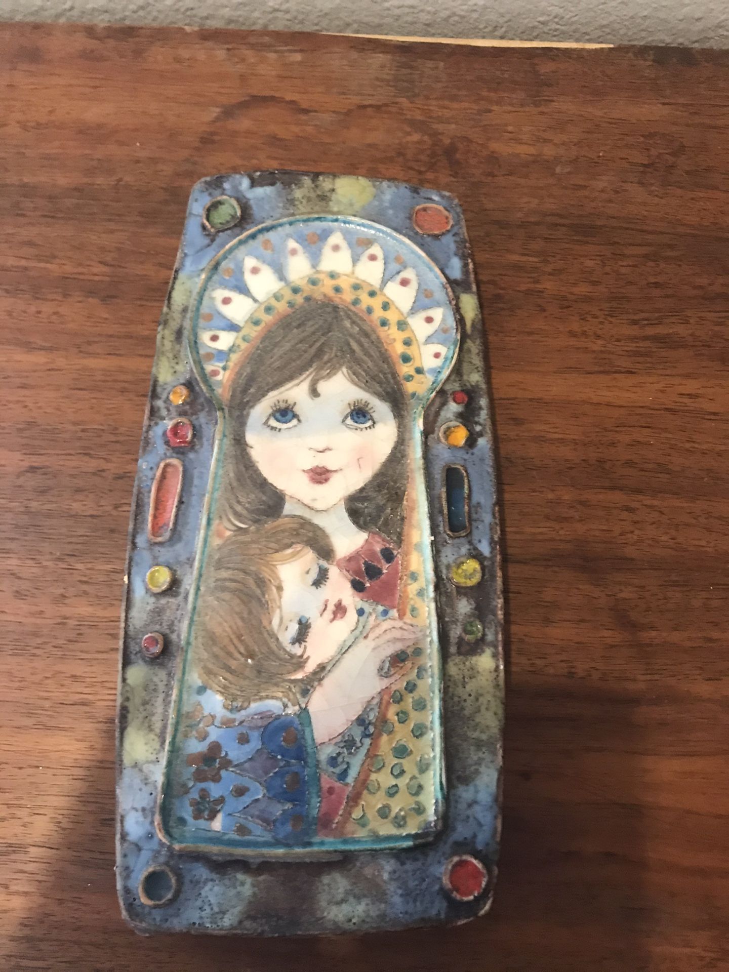 hand painted pottery wall plaque depicting a stylized version of Madonna and Child signed Lino Z from Italy.