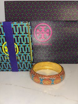 Signed Joan Rivers vintage 1990 collectible oval hinged bangle enamel bracelet in a vibrant orange, blue, and lavender pattern on a gold-tone finish. 