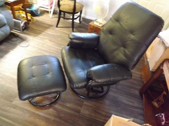Black soft swivel chair with foot stool, plus a rocker with cushions and foot stool that rocks also