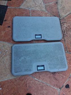 The object in the image is a gray Redmon XL Field Scale, a digital multi-use platform scale featuring an integrated LCD screen and a high weight capac